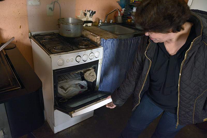 A woman in Mexico uses her LPG stove for storage instead of cooking