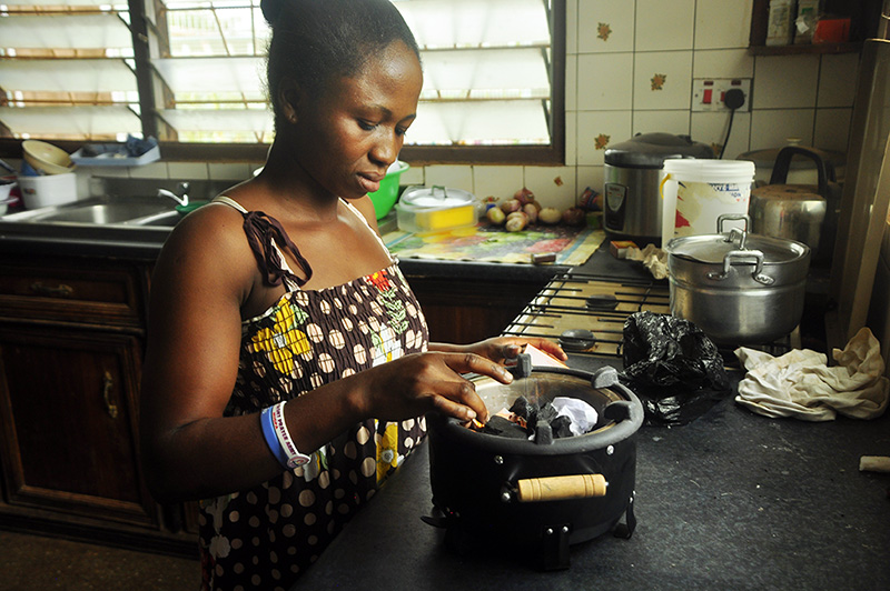Daina chooses to cook on her charcoal stove instead of the LPG stove she has in her kitchen