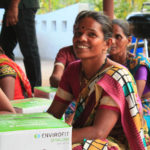 A woman in Kharkharadi, India smiles with her new clena cookstove